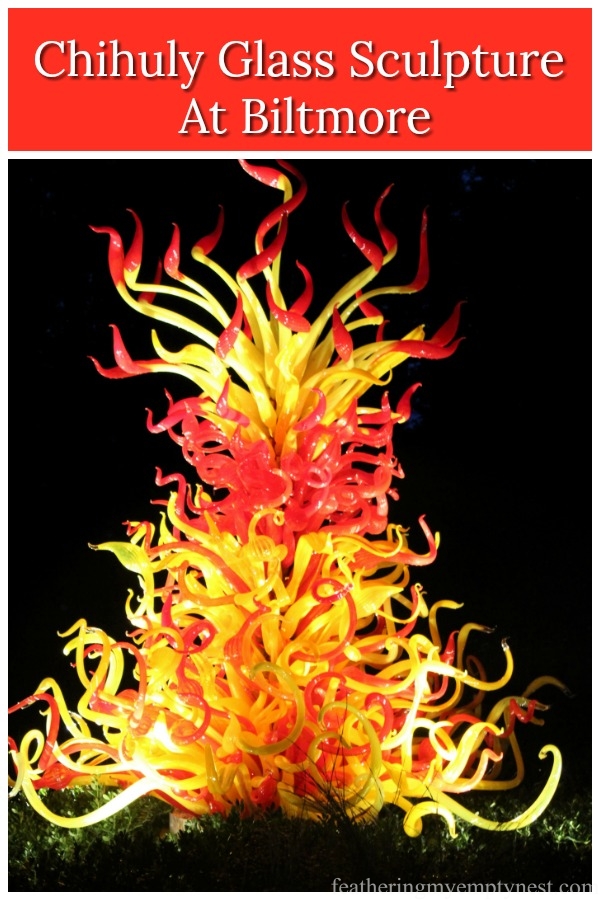 Explore the stunning glass sculpture of famed artist, Dale Chihuly in the lush gardens of Biltmore. #gardens, #Biltmore, #Chihuly, #glass sculpture